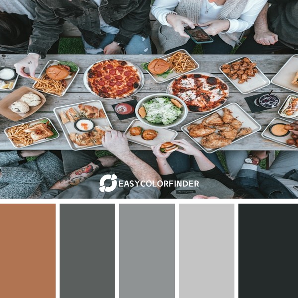 a group of people sitting around a table with food